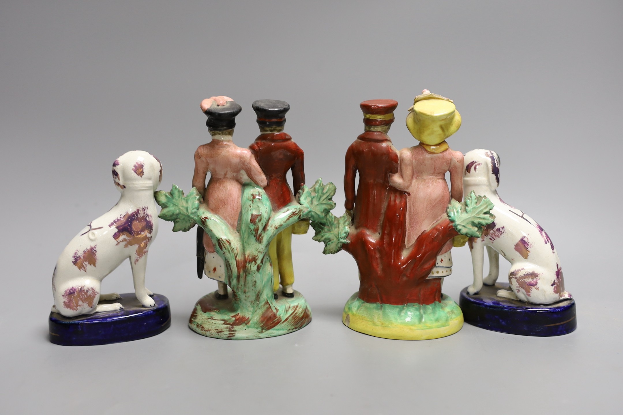 A pair of Staffordshire pink lustre spaniels and a pair of similar groups of a dandy and dandizette , 16.5cm